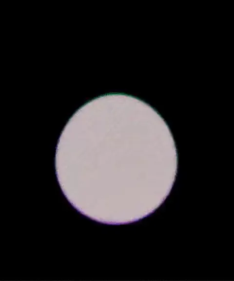 Short loop: a soap-bubble ring on black morphs into a white blob, then a glowing blue-green orb on a pink stem.
