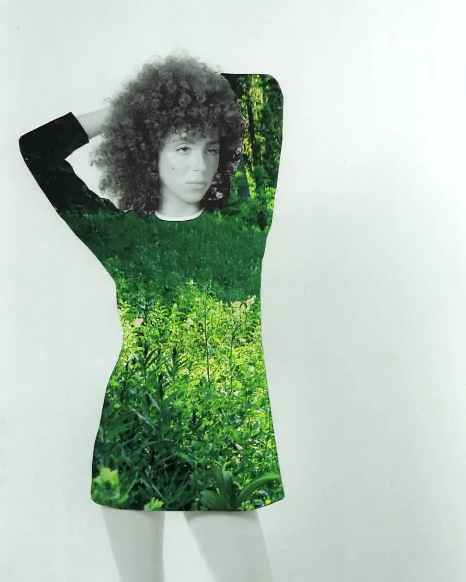 4.6 s 4K loop with audio: black-and-white model with curly hair whose dress cycles through fern greenery, yellow tree canopy and red roses.