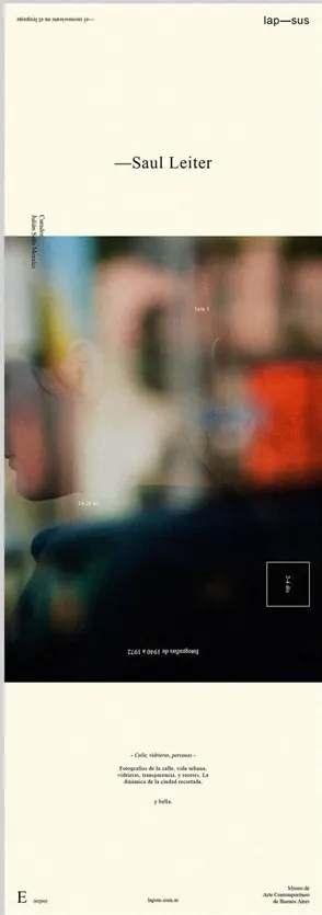 Minimal editorial layout with a blurred street photo and small serif type.