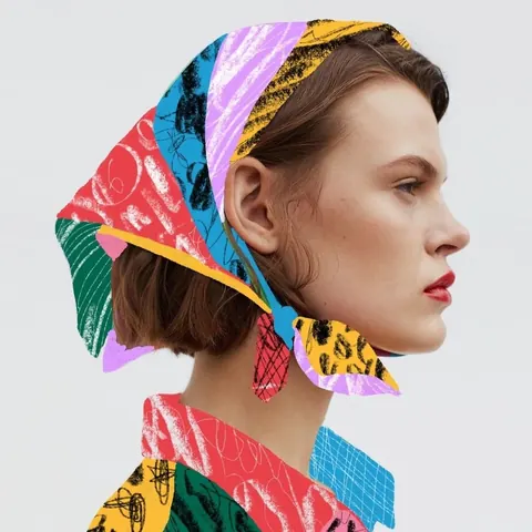 Profile photo of a woman whose headscarf and collar are drawn over in bright crayon scribbles.